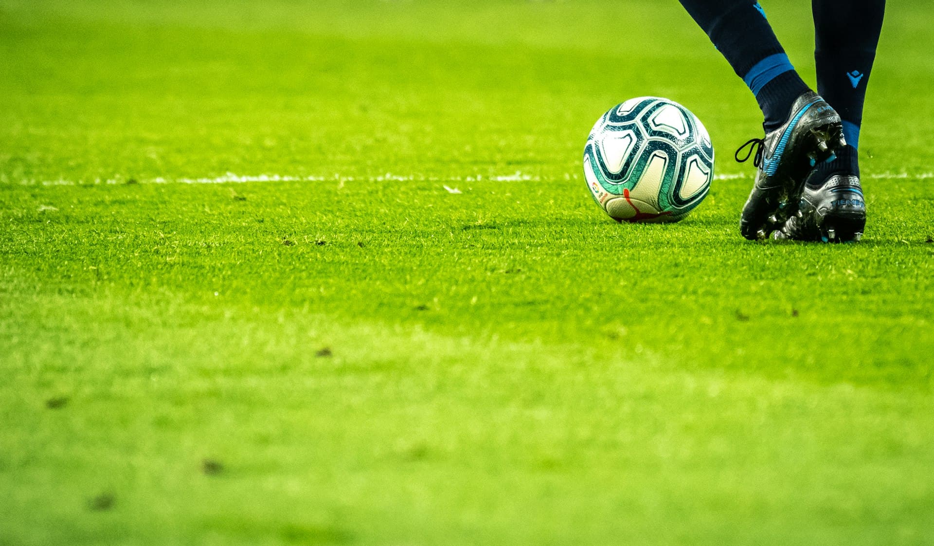Grassroots football match under floodlights